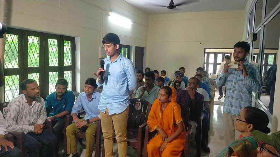 A young participant speaking before an audience