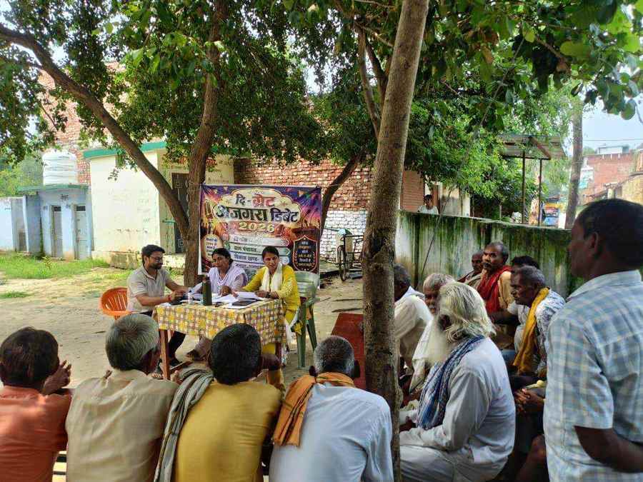 Villagers gathered beneath a tree for a dialogue